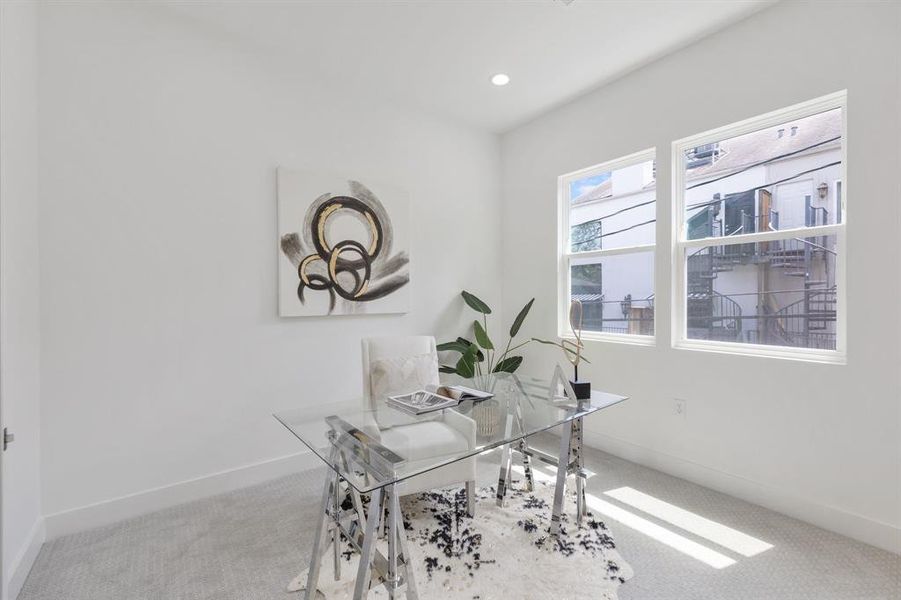 This secondary bedroom, located on the second floor is currently shown as an office space.  It feature a full closet with chrome rods, dresser and ensuite bathroom.