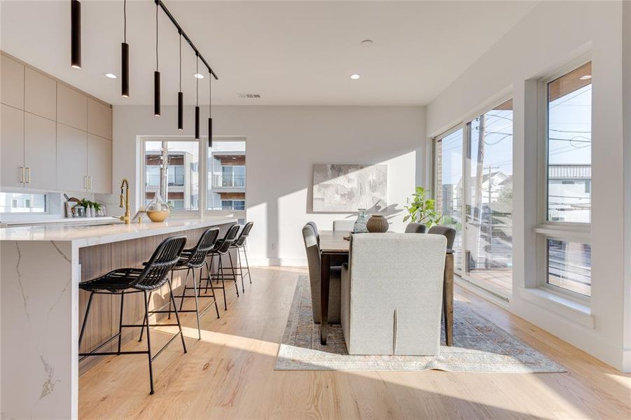 Dining area with light hardwood / wood-style flooring and sink