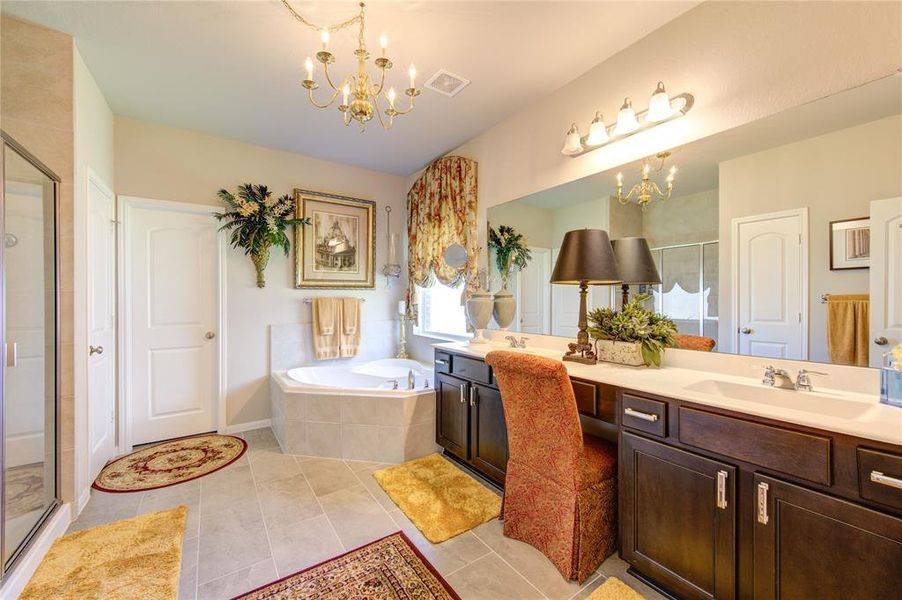Large Primary bathroom with separate walk in showing and garden tub
