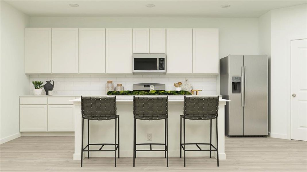 Kitchen with stainless steel appliances, light hardwood / wood-style floors, white cabinetry, and tasteful backsplash