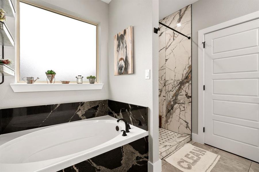 Separate Shower with Large Soaking Tub and Frosted Glass Window.