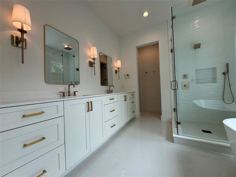 Bathroom featuring tile patterned flooring, plus walk in shower, and dual bowl vanity