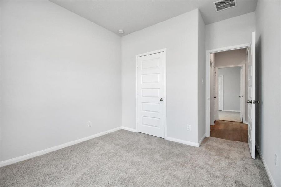 Generously sized secondary bedrooms featuring spacious closets, soft and inviting carpeting underfoot and large windows allowing plenty of natural light.