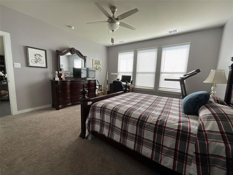 Bedroom featuring light carpet and ceiling fan