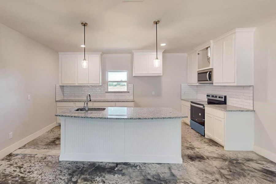 Kitchen featuring white cabinets, tasteful backsplash, appliances with stainless steel finishes, and sink