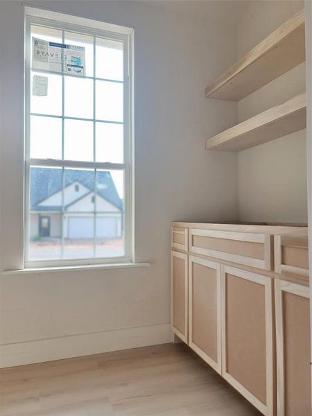Window, utility sink, shelving, and work bench