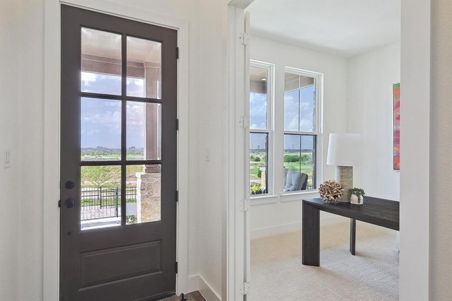 Doorway to outside featuring carpet flooring