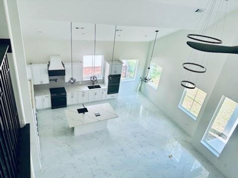 Soaring 2 story ceilings open to game room