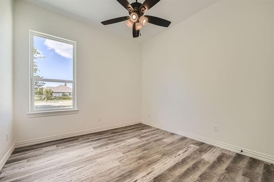 Spare room with ceiling fan and light hardwood / wood-style flooring