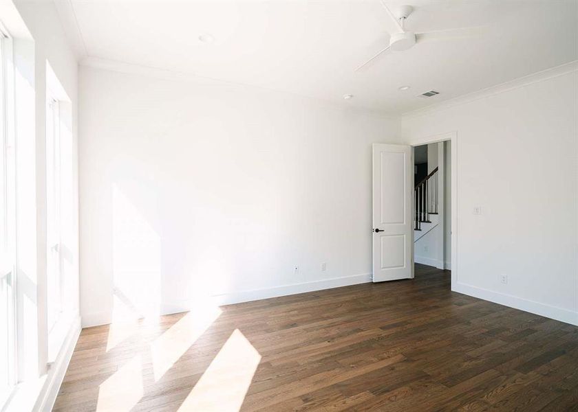 Spare room with ceiling fan, ornamental molding, and hardwood / wood-style floors