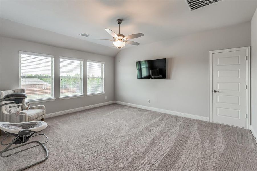 Living area featuring carpet flooring and ceiling fan