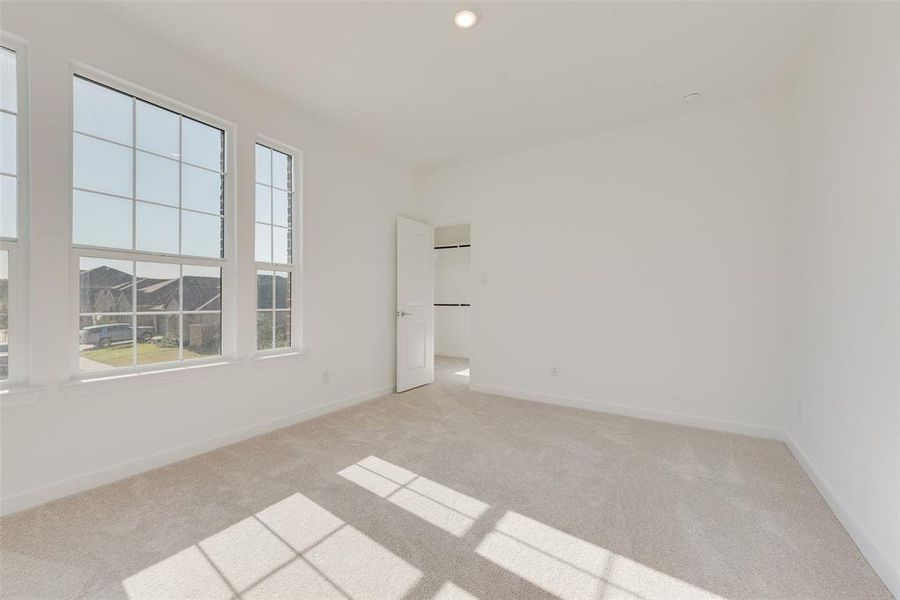 Carpeted spare room with a wealth of natural light