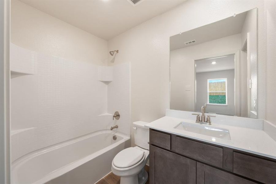 Full bathroom featuring shower / bathtub combination, wood-style flooring, vanity, and toilet