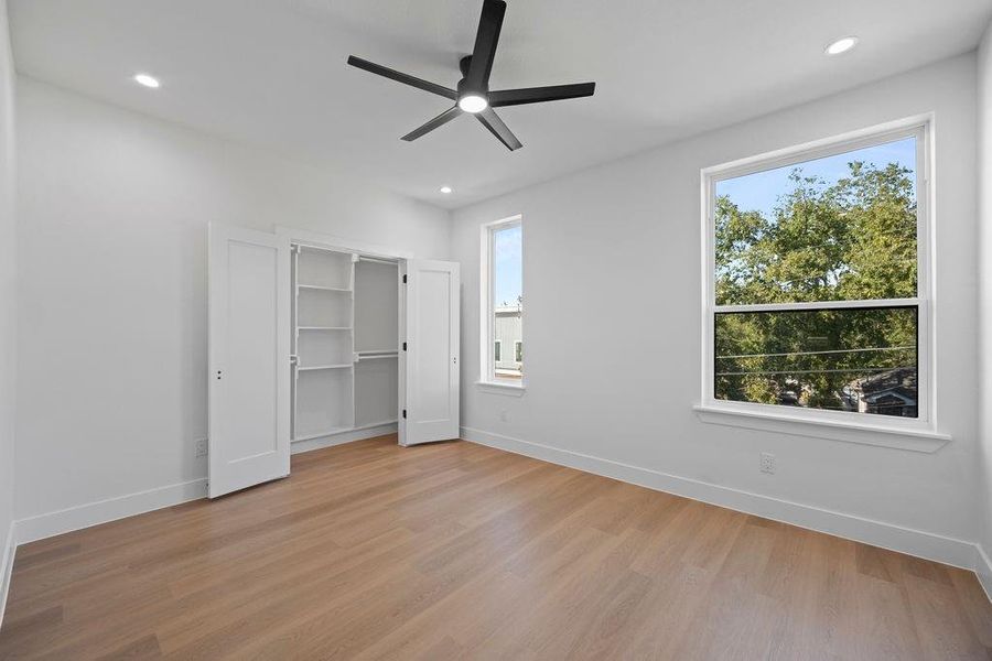 Unfurnished bedroom featuring light wood-type flooring and ceiling fan