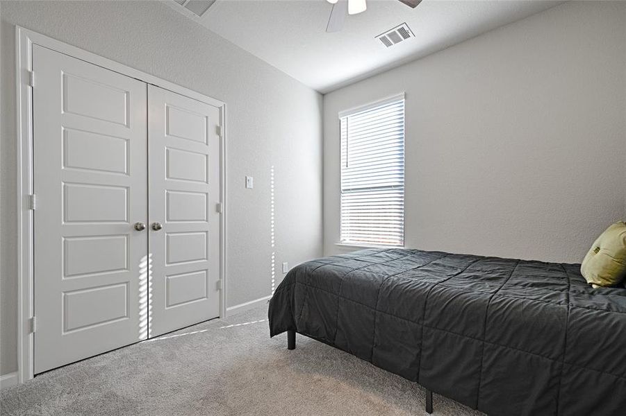 Bedroom featuring a closet, carpet, and ceiling fan