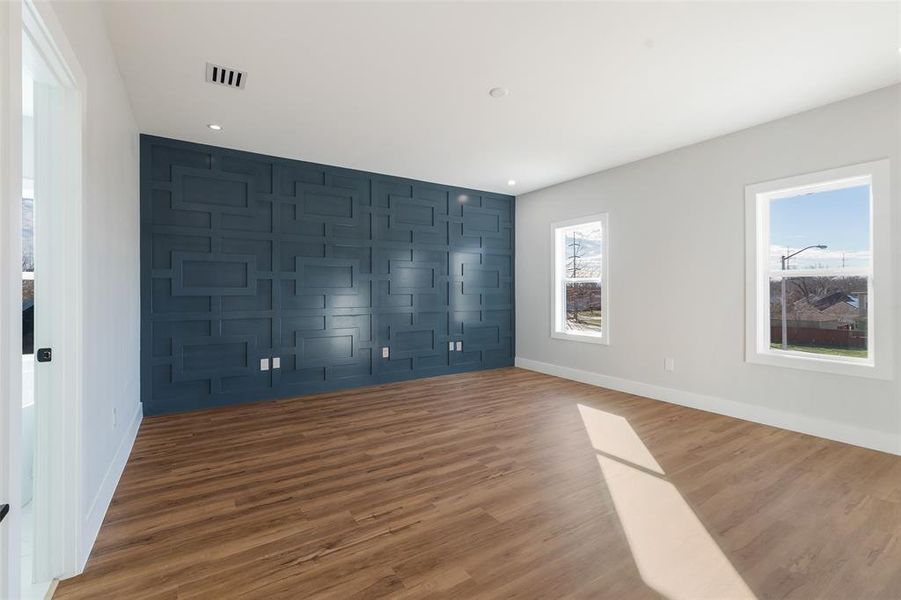 Unfurnished bedroom featuring dark hardwood / wood-style flooring