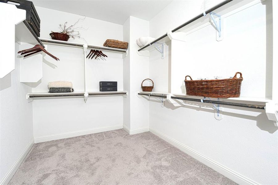 luxury walk-in closet offfering plenty of space for you wardrobe, ample hanging space, features designed areas for accesories, shoes and more.