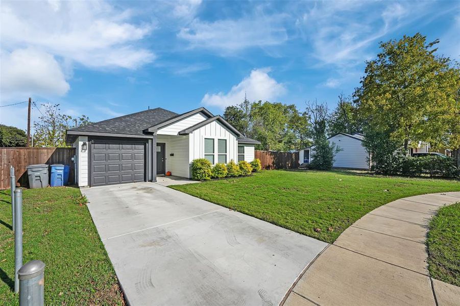 Single story home with a front lawn and a garage