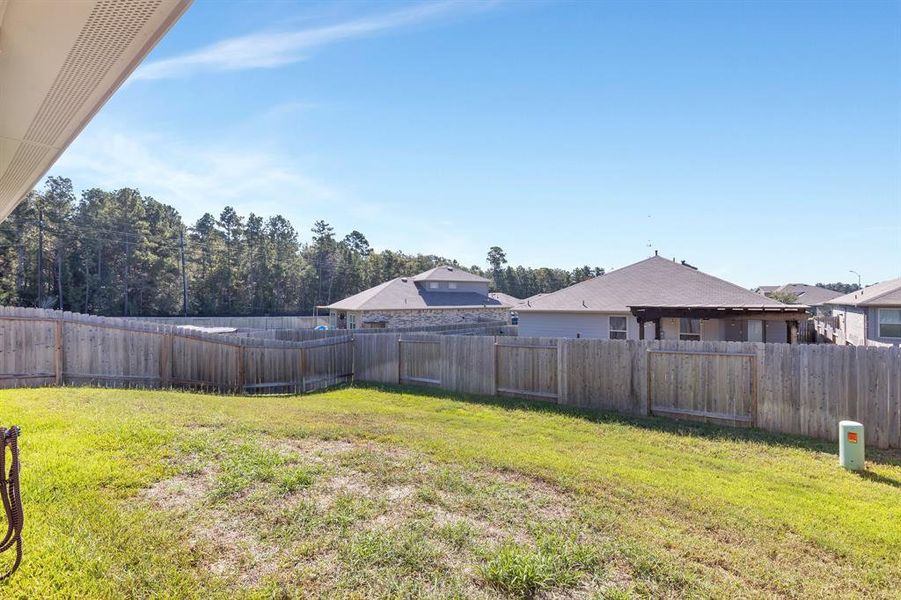 Spacious backyard offers endless possibilities for transformation, whether you envision a fantastic play area for kids or a stunning pool retreat surrounded by a retaining wall of beautiful shade trees. This outdoor space is perfect for creating your dream landscape and enjoying outdoor activities year-round.