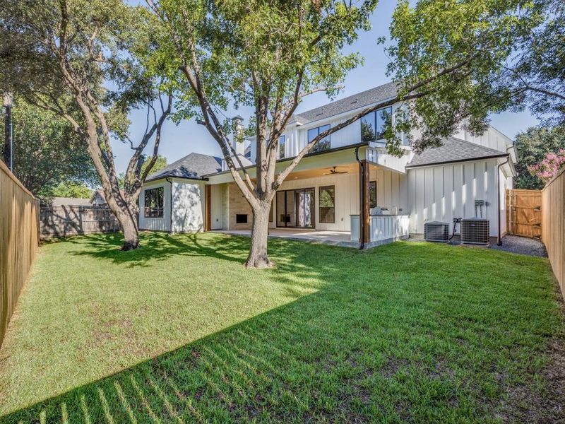 Back of house featuring a lawn, ceiling fan, a patio, and central AC