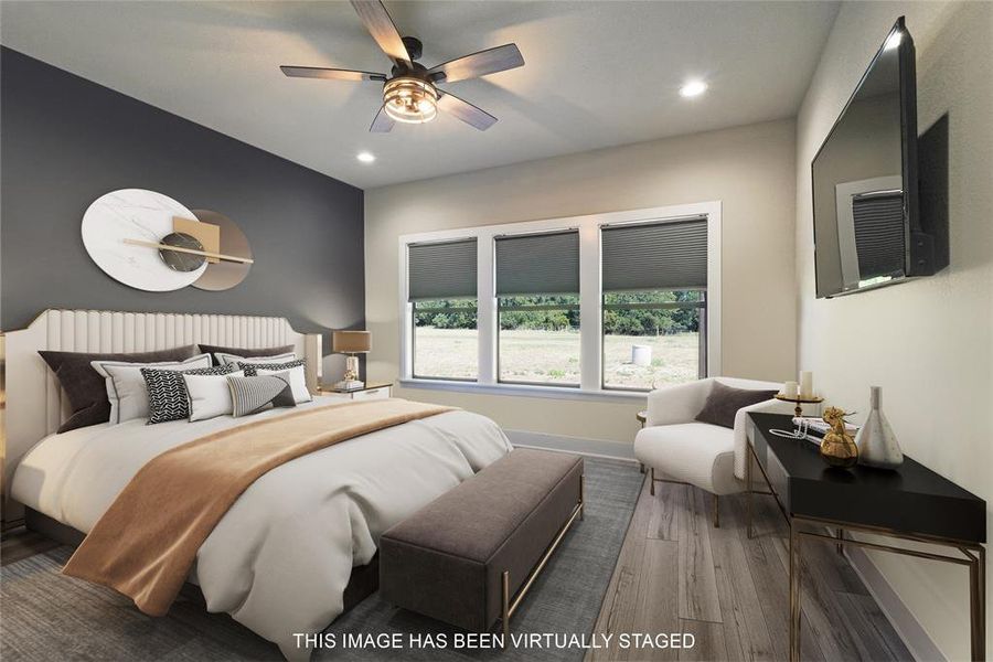 Primary Bedroom with wood-type flooring and ceiling fan