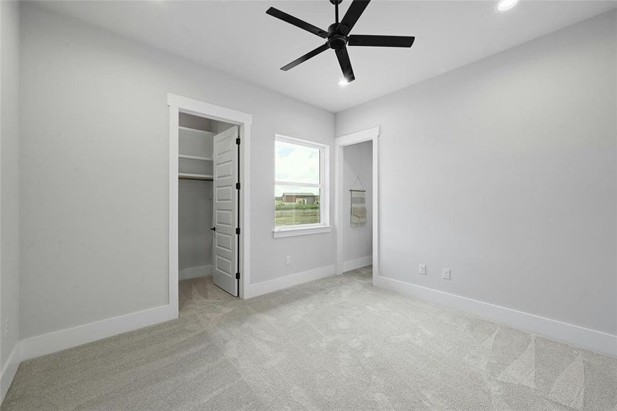 One of the four bedrooms with large window, walk in closet, recessed lighting and ceiling fan.