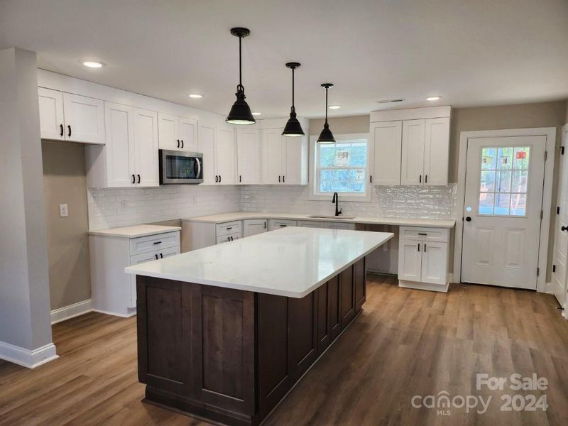 Each Kitchen 8 ft Quartz Island& Stainless Appliances.