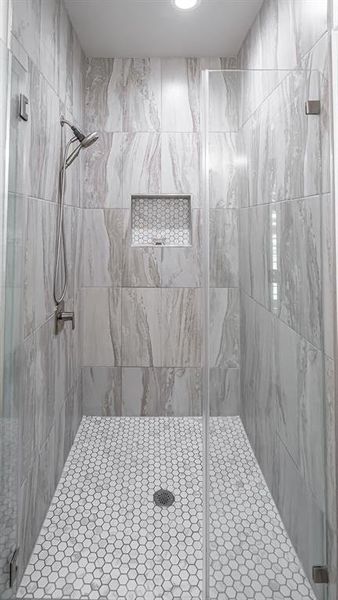 Primary Bathroom featuring a shower with shower door