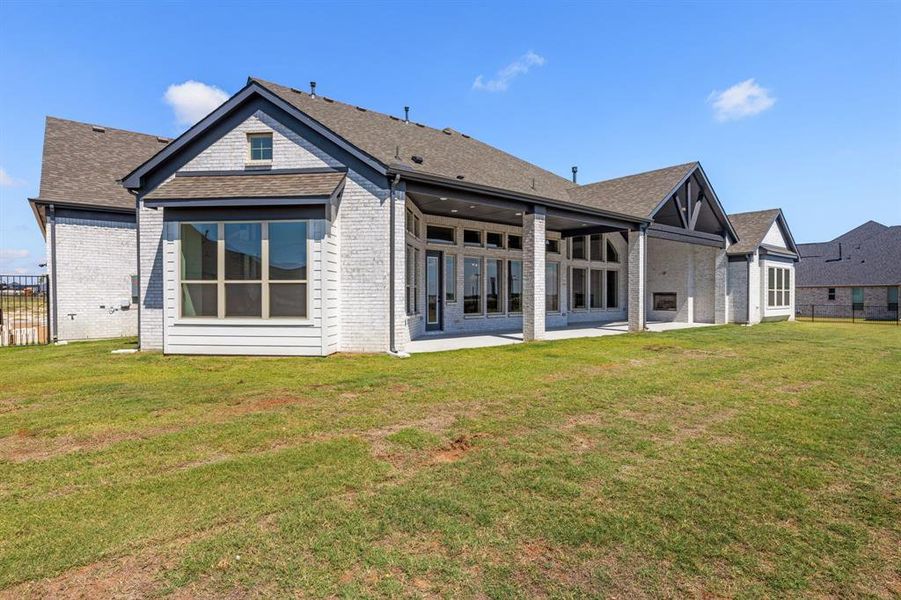 Back of house featuring a patio and a yard