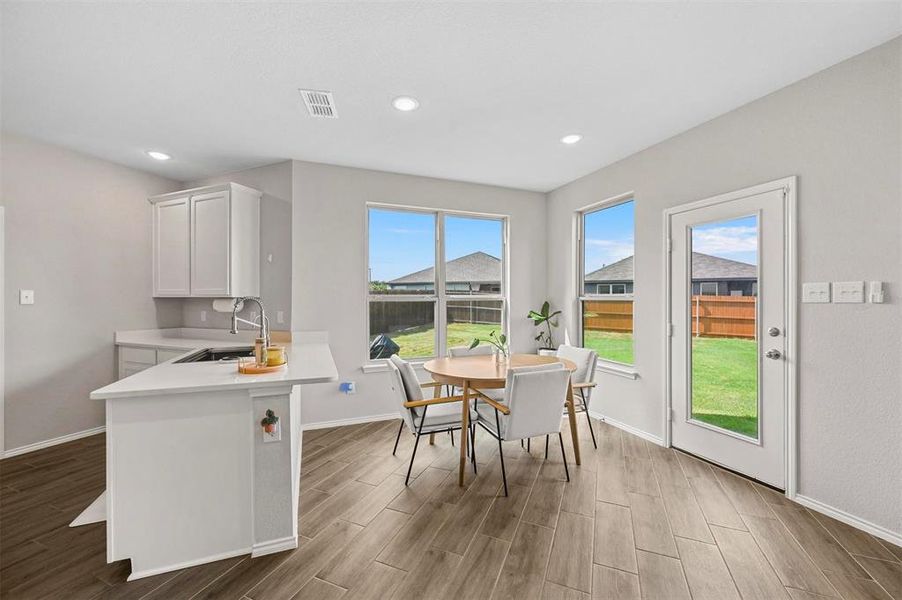 Dining space with light wood-type flooring and sink