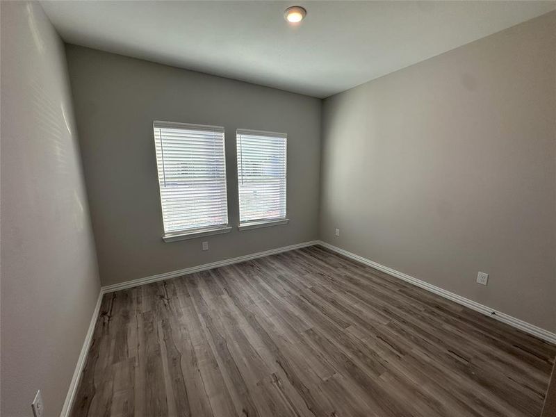 Unfurnished room featuring dark hardwood / wood-style floors