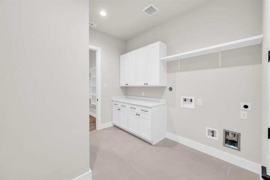 Laundry room with plenty of counter and cabinet space