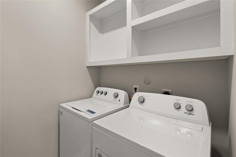 The laundry room layout is carefully planned for optimal workflow with designated areas for washing, drying, and storing.