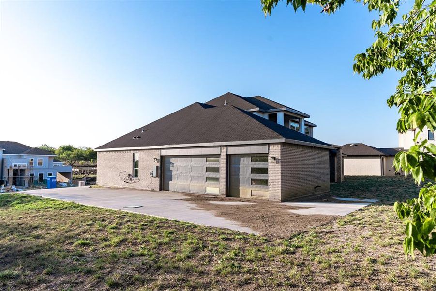 Rear view of house featuring a patio and a yard