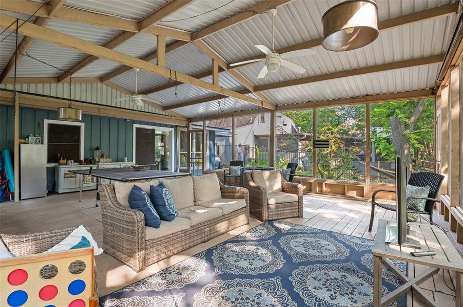 HUGE screened in deck with lofted ceiling with beams and ceiling fan