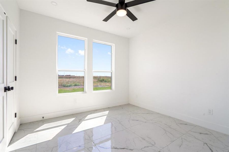 Unfurnished room featuring ceiling fan