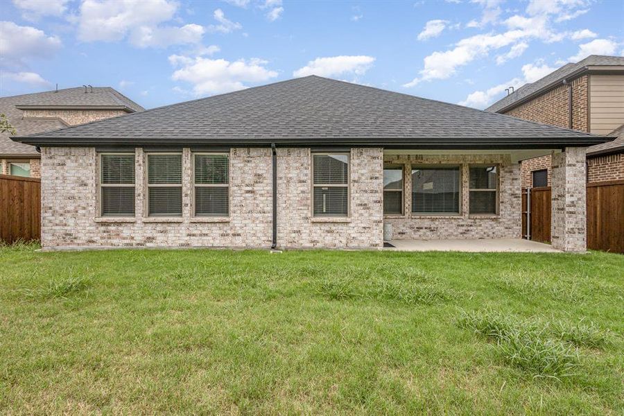 Back of house featuring a patio area and a lawn