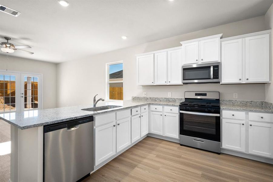 Stainless Steel appliances with white cabinets makes this kitchen chef-ready.