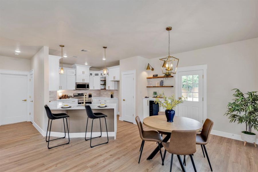 Dining room featuring an inviting chandelier and light hardwood / wood-style flooring