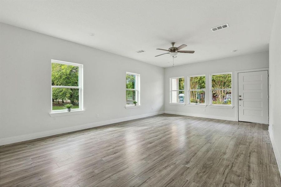 Spare room with hardwood / wood-style floors and ceiling fan