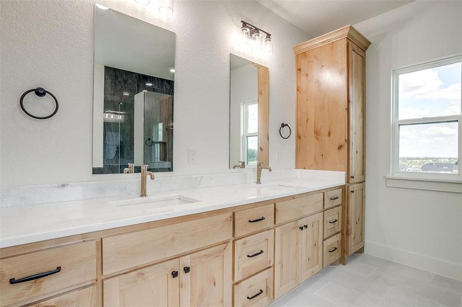 Bathroom with tile patterned flooring, walk in shower, and vanity