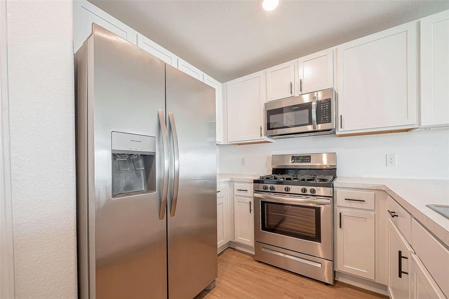 The kitchen boasts ample cabinet and counter space, providing plenty of room for storage and meal preparation.