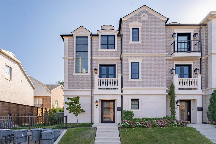 View of front facade with a front lawn and a balcony