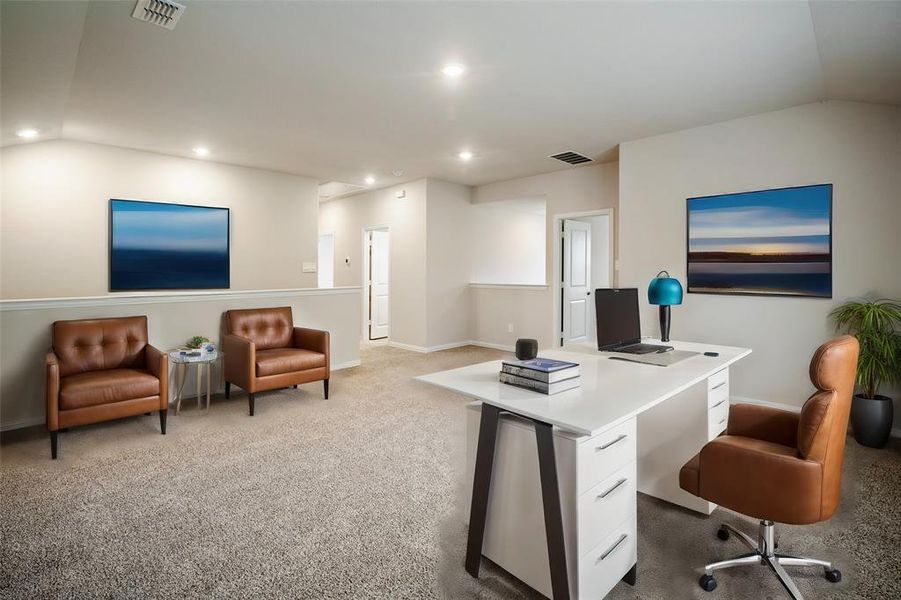 Carpeted office space with vaulted ceiling