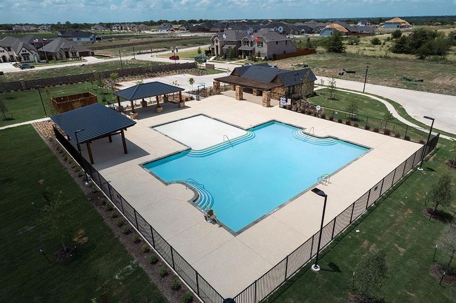 View of swimming pool with a patio and a yard