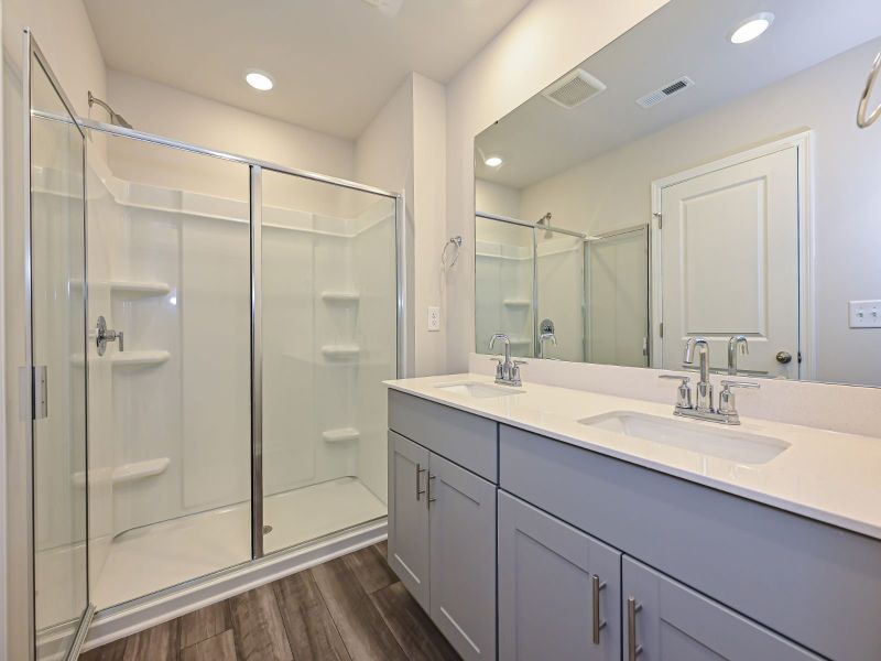 The primary suite boasts a private ensuite with dual sinks and a walk-in closet.