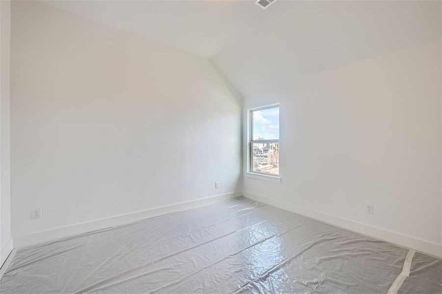 Bedroom room with lofted ceiling