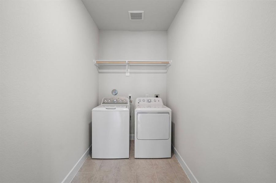 Walk-in laundry room with both gas and electric dryer connections.