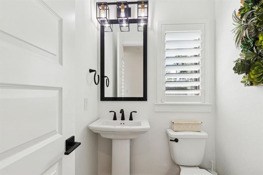 Hospitality is felt throughout the home and the powder room is no exception. Antiqued in style, the lovely pedestal sink is just the right size for visitors and guests.