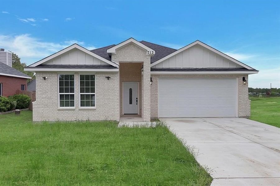 Ranch-style house with a front yard and a garage